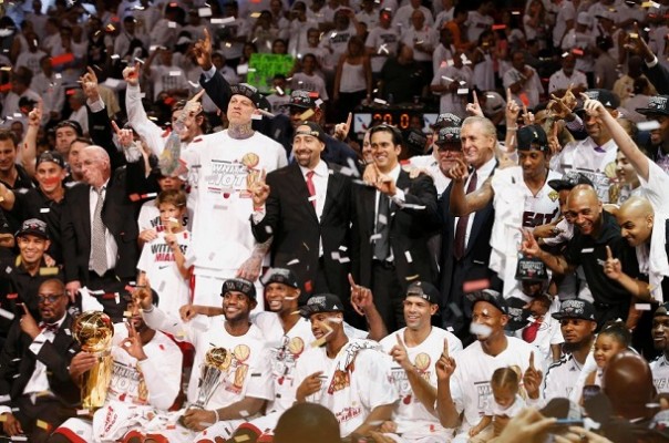 The Miami Heat players, coaches, owner and other staff pose with the Larry O'Brien Championship Trophy after their team defeated the San Antonio Spurs in Game 7 to win the NBA Finals basketball playoff in Miami